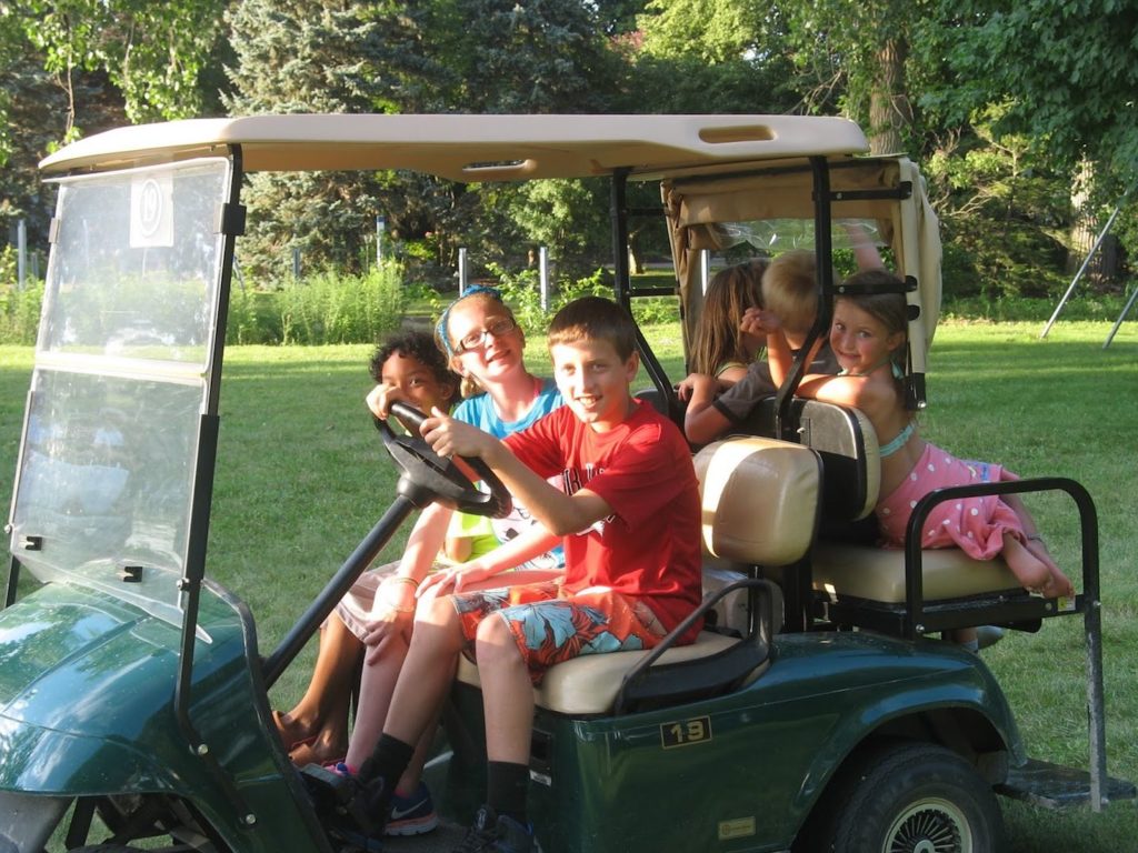 kids driving golf cart