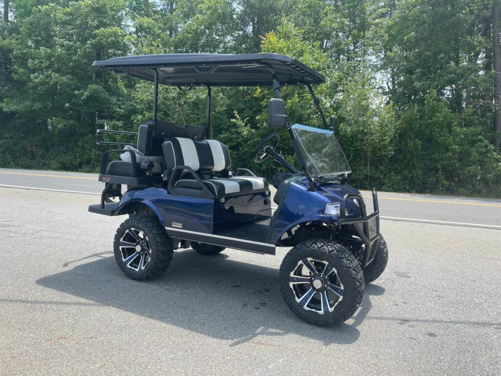 2023 EVolution Forester Golf cart in Midnight Blue with black and white seats, lift kit, premium wheels only at J's Golf Carts