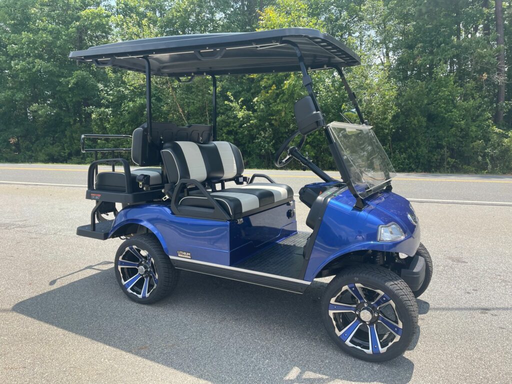 2023 EVolution Classic cart in Pacific Blue with black and white seats and the street legal package including headlights, tail lights, turn signals, horn and seatbelts.