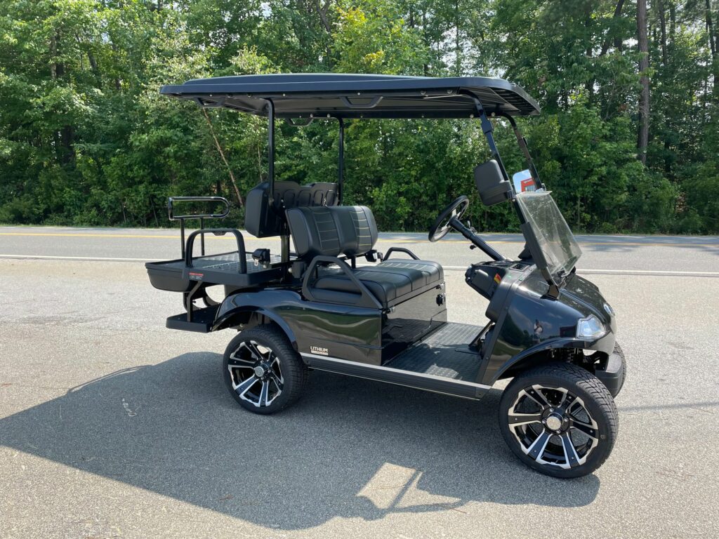 2023 EVolution Classic cart in Black with black and white seats and the street legal package including headlights, tail lights, turn signals, horn and seatbelts.