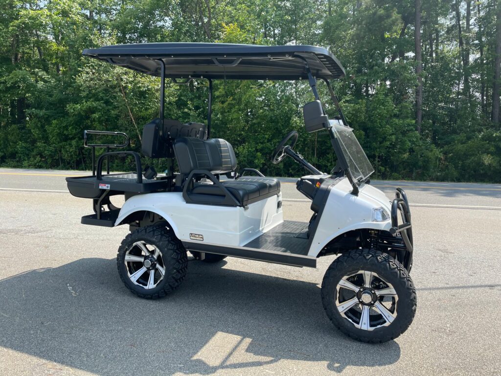 2023 EVolution Forester Golf cart in White with black and white seats, lift kit, premium wheels only at J's Golf Carts